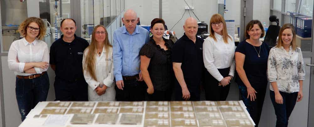 Poeton-Polska-First-customer-order Poeton Polska team with a table of parts that have been processed