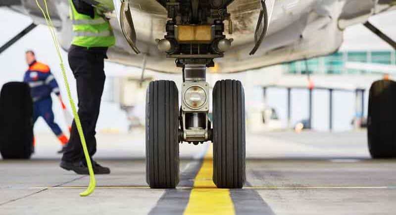 Aircraft-tyre-web Aircraft tyre and landing gear on a runway